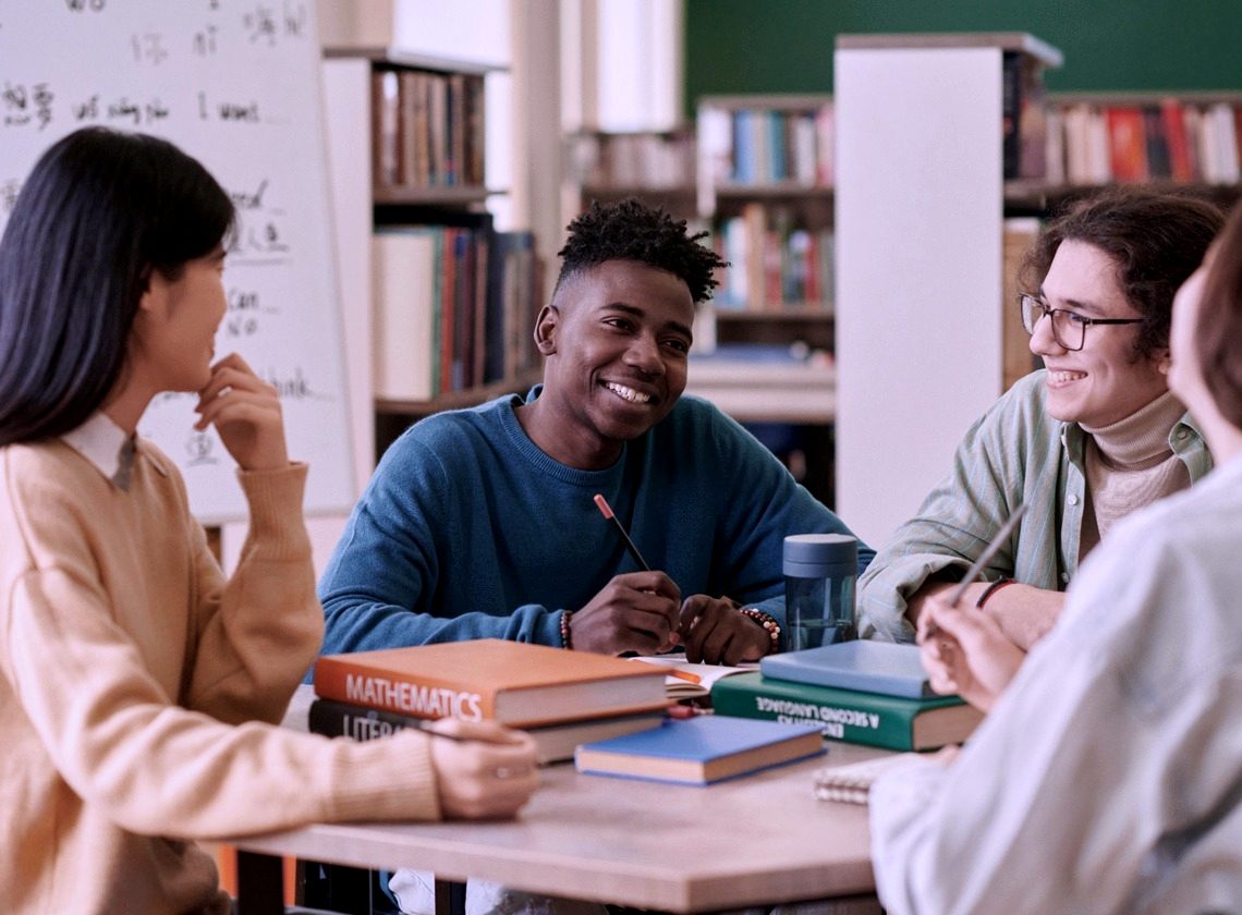 A study group talking around a library table